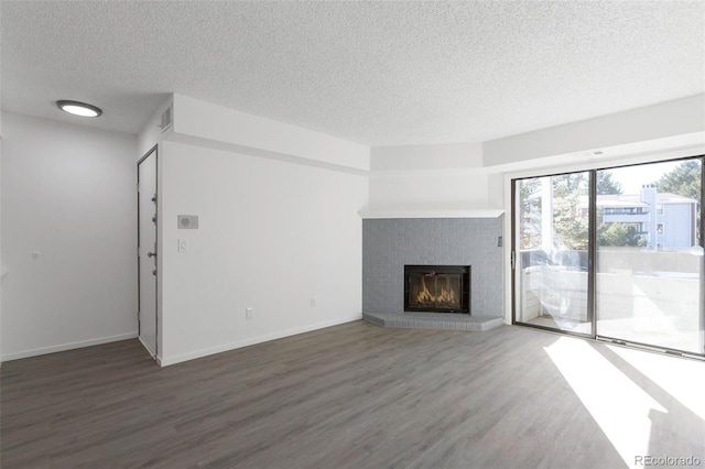 unfurnished living room featuring a textured ceiling and dark wood-type flooring