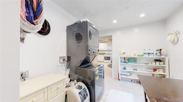 10993 Barker Ave, Conifer, CO 80433 - washroom featuring stacked washer and clothes dryer, recessed lighting, and cabinet space
