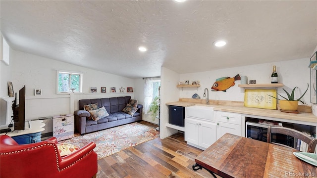 10993 Barker Ave, Conifer, CO 80433 - living area featuring wood finished floors, lofted ceiling, a textured ceiling, and recessed lighting