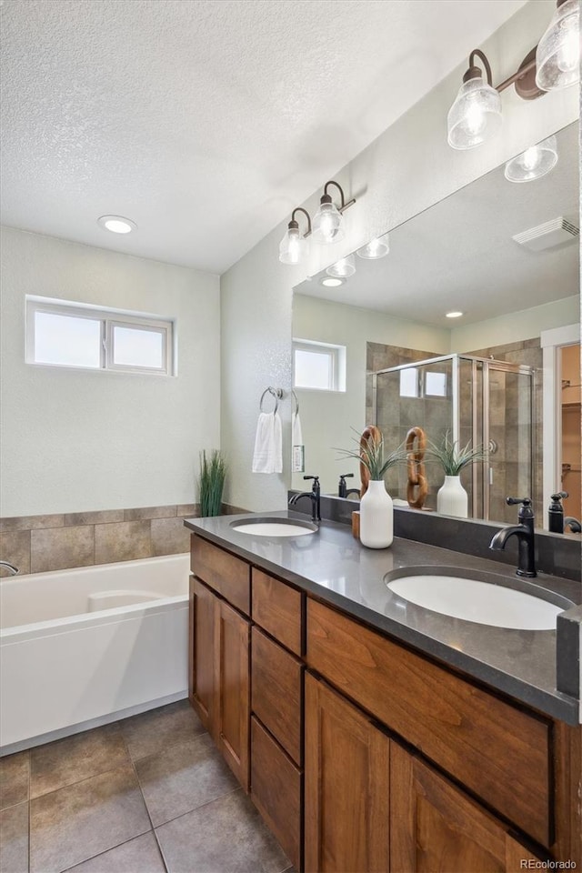 bathroom featuring a sink, a wealth of natural light, and a shower stall