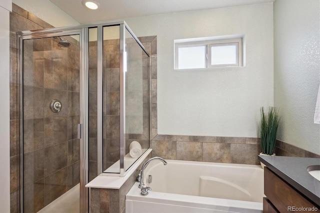 bathroom featuring vanity, a shower stall, and a bath