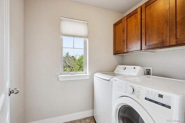 laundry area with baseboards, cabinet space, and washer and clothes dryer