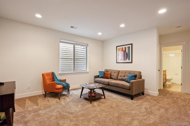 carpeted living area featuring baseboards, recessed lighting, and visible vents
