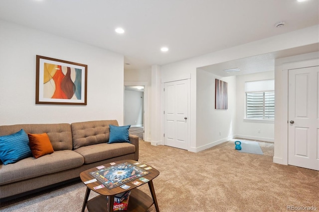 living area with baseboards, recessed lighting, and light colored carpet