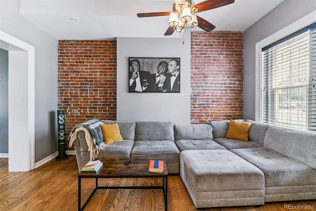 909 W Park Ave, Denver, CO 80205 - living area with a ceiling fan, wood finished floors, and brick wall