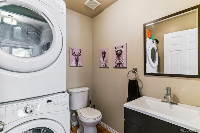 909 W Park Ave, Denver, CO 80205 - bathroom featuring stacked washer and clothes dryer, vanity, and wood finished floors