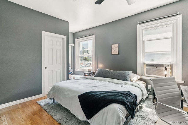 909 W Park Ave, Denver, CO 80205 - bedroom featuring wood finished floors, cooling unit, and ceiling fan