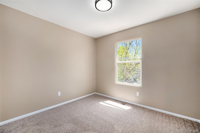 spare room with carpet floors and baseboards