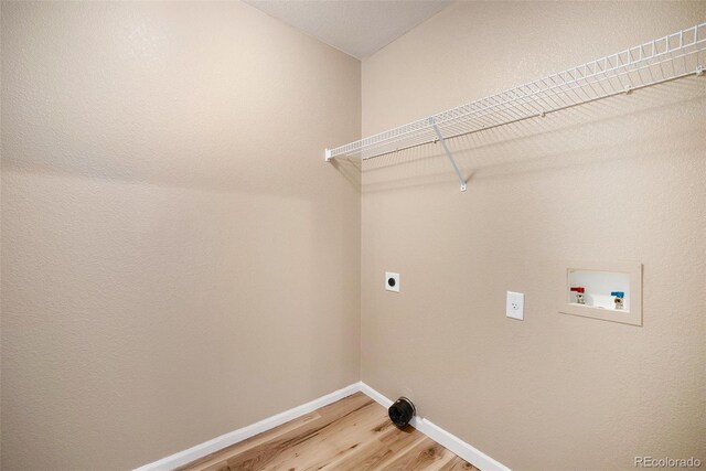 laundry area with washer hookup, laundry area, light wood-style flooring, baseboards, and hookup for an electric dryer