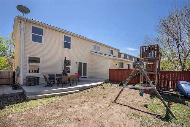 rear view of house with a playground, fence, a patio, and cooling unit