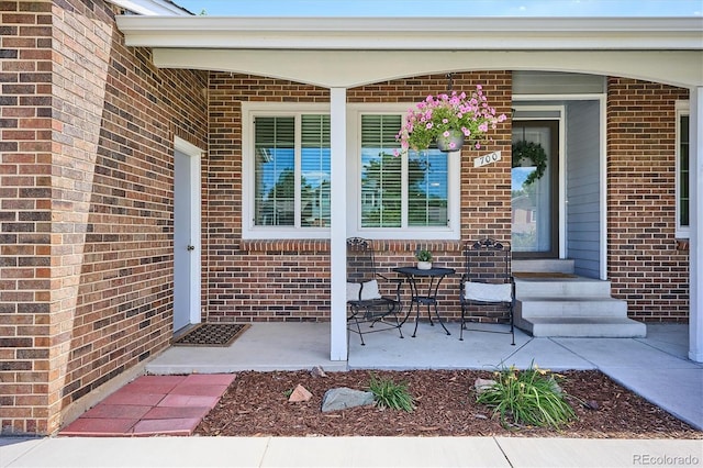700 Prairie Ridge Rd, Highlands Ranch, CO 80126 - doorway to property featuring brick siding and covered porch