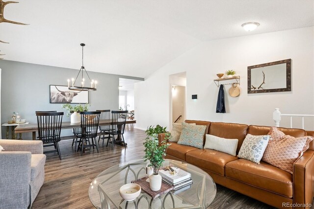 700 Prairie Ridge Rd, Highlands Ranch, CO 80126 - living room with wood finished floors, lofted ceiling, and a chandelier