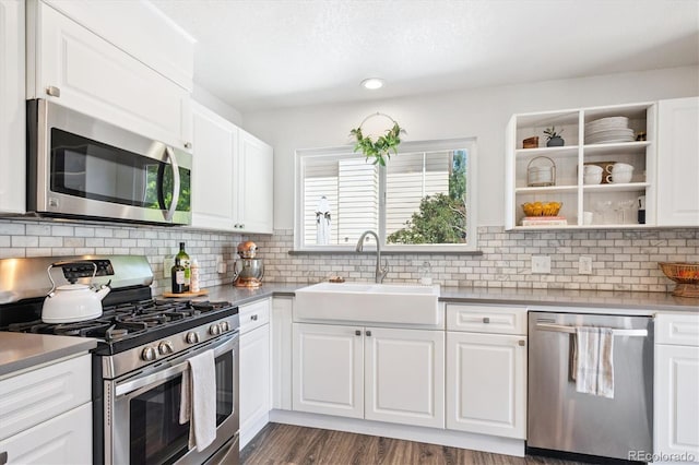 700 Prairie Ridge Rd, Highlands Ranch, CO 80126 - kitchen featuring stainless steel appliances, white cabinets, tasteful backsplash, dark wood finished floors, and recessed lighting