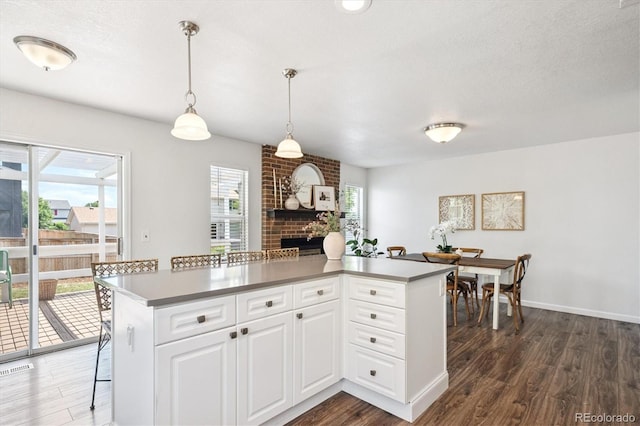 700 Prairie Ridge Rd, Highlands Ranch, CO 80126 - kitchen with healthy amount of natural light, dark wood-style flooring, and a kitchen island