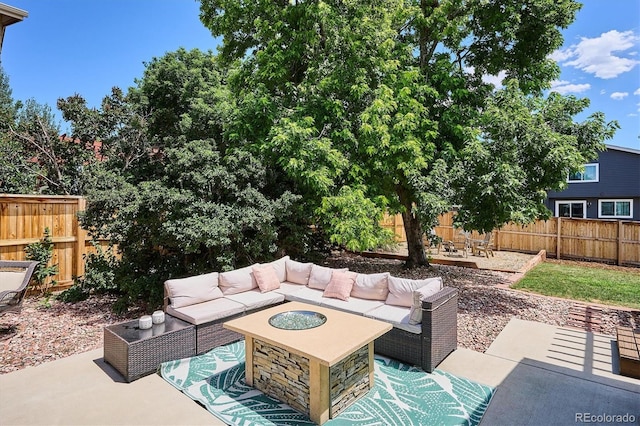 700 Prairie Ridge Rd, Highlands Ranch, CO 80126 - fenced backyard featuring an outdoor living space with a fire pit and a patio