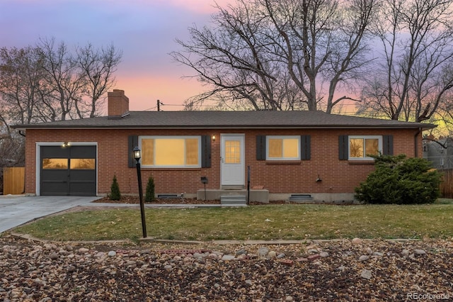 single story home with a yard and a garage