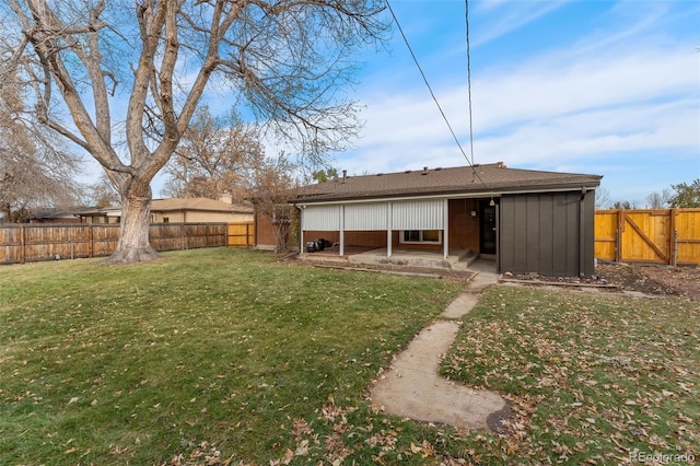 back of property featuring a patio area and a yard