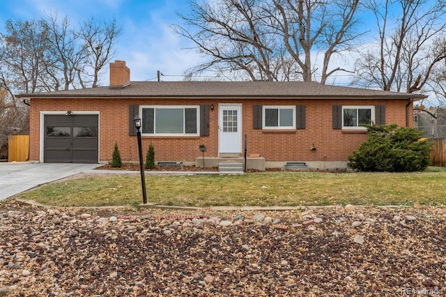 ranch-style house with a garage and a front lawn