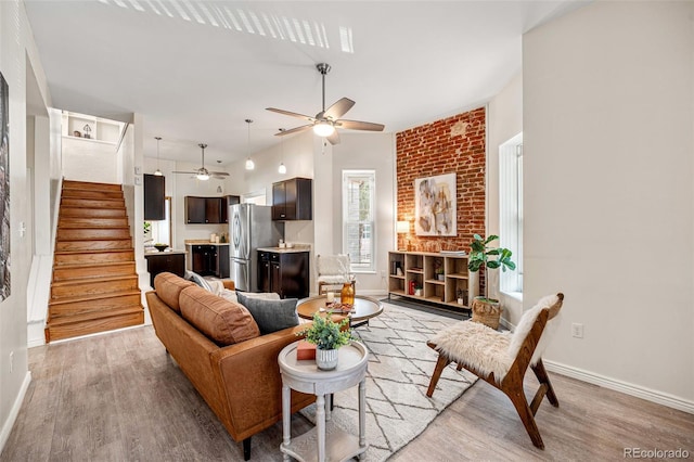 1516 Lafayette St, Denver, CO 80218 - living room featuring a ceiling fan, light wood-style floors, stairs, and baseboards