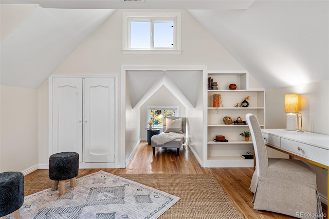 1516 Lafayette St, Denver, CO 80218 - living area with wood finished floors, plenty of natural light, lofted ceiling, built in features, and baseboards