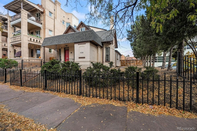 1516 Lafayette St, Denver, CO 80218 - view of front of home featuring brick siding, a shingled roof, and a fenced front yard