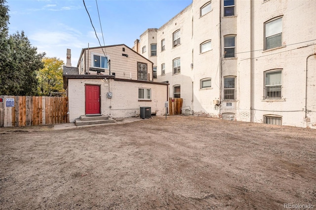 1516 Lafayette St, Denver, CO 80218 - rear view of house with central AC unit, fence, brick siding, and a chimney