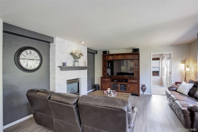 15432 Greenstone Cir, Parker, CO 80134 - living area with light wood-style flooring and a fireplace