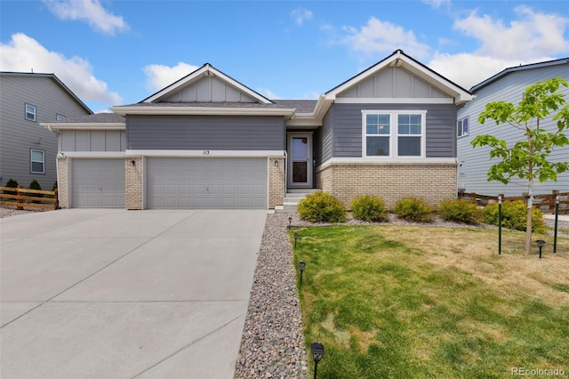 113 Marlowe Dr, Erie, CO 80516 - view of front of home with board and batten siding, brick siding, a garage, a front lawn, and concrete driveway
