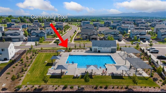 113 Marlowe Dr, Erie, CO 80516 - aerial perspective of suburban area featuring a pool and a mountain backdrop