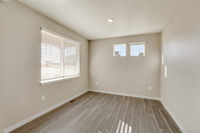 unfurnished room with light wood-type flooring