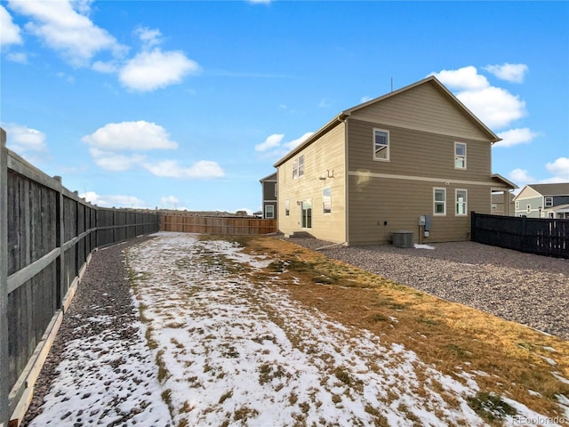 view of snow covered rear of property