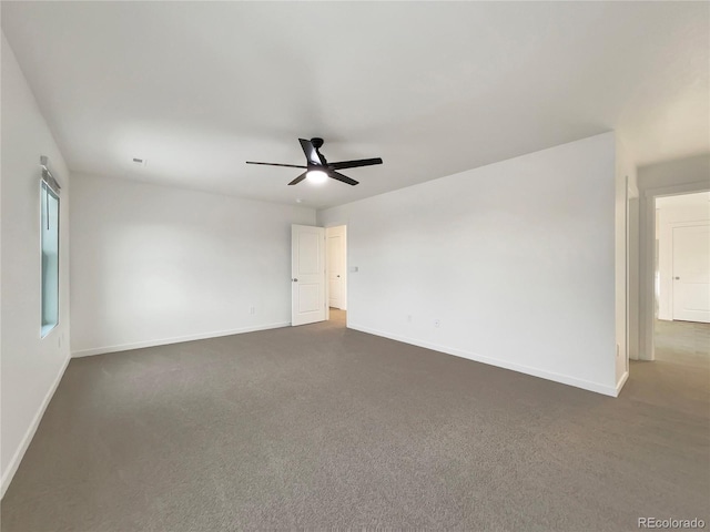 carpeted spare room with ceiling fan