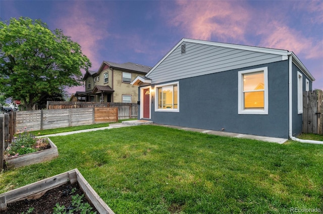 1414 W Nevada Pl, Denver, CO 80223 - rear view of property with a garden and stucco siding
