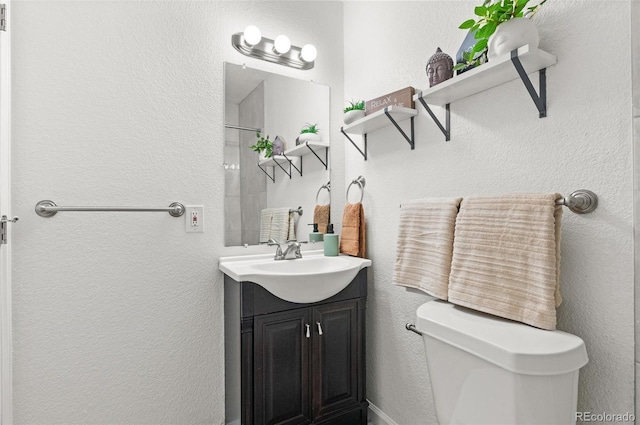 1414 W Nevada Pl, Denver, CO 80223 - full bathroom featuring toilet, vanity, a shower, and a textured wall
