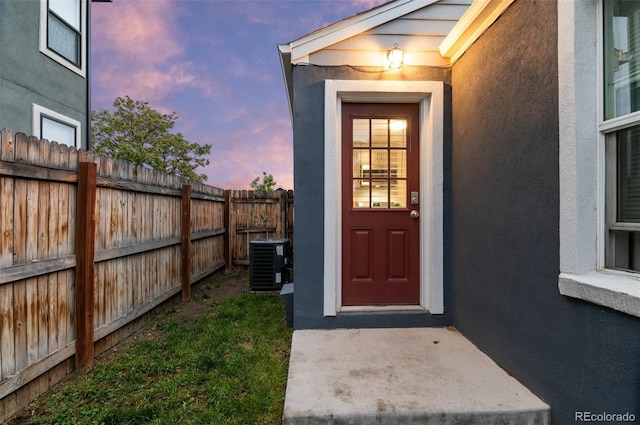 1414 W Nevada Pl, Denver, CO 80223 - exterior entry at dusk with stucco siding and central AC