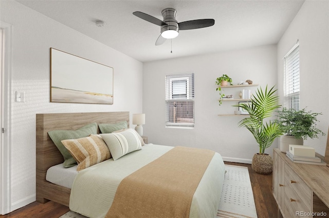 1414 W Nevada Pl, Denver, CO 80223 - bedroom with wood finished floors, multiple windows, baseboards, and ceiling fan