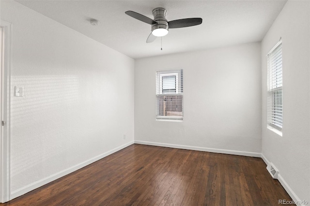1414 W Nevada Pl, Denver, CO 80223 - empty room featuring dark wood-style floors, plenty of natural light, and baseboards