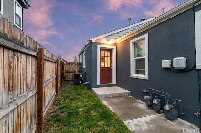1414 W Nevada Pl, Denver, CO 80223 - property entrance with central AC unit, stucco siding, and a patio area