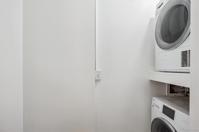 laundry area with stacked washer and clothes dryer