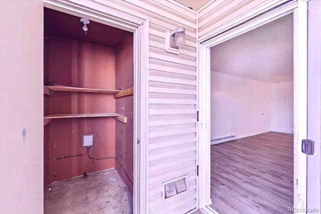 view of exterior entry featuring baseboard heating