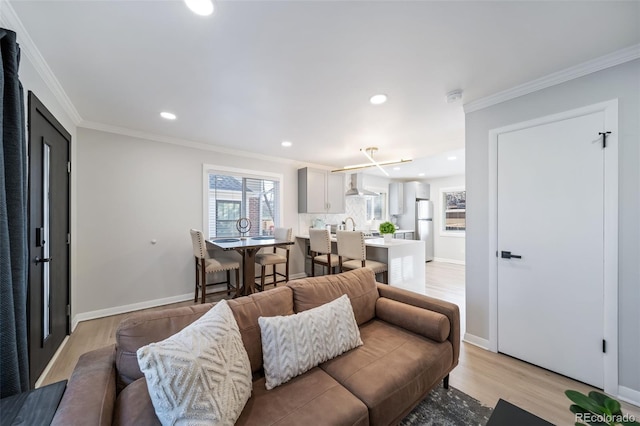 living room with light hardwood / wood-style floors and ornamental molding