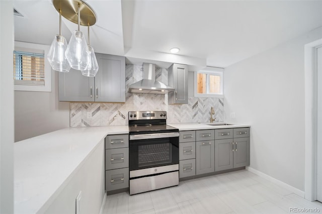 kitchen featuring backsplash, wall chimney exhaust hood, stainless steel electric stove, sink, and hanging light fixtures