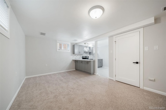 unfurnished living room featuring light colored carpet