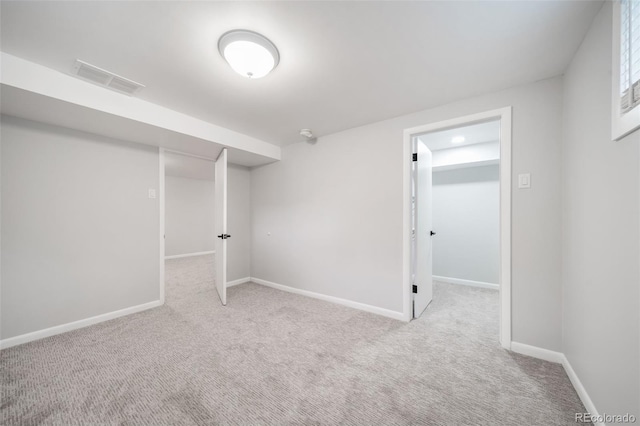 basement featuring light colored carpet