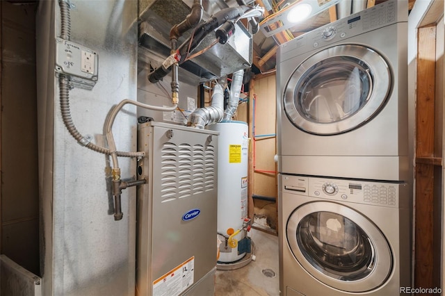 clothes washing area featuring stacked washer and dryer and water heater