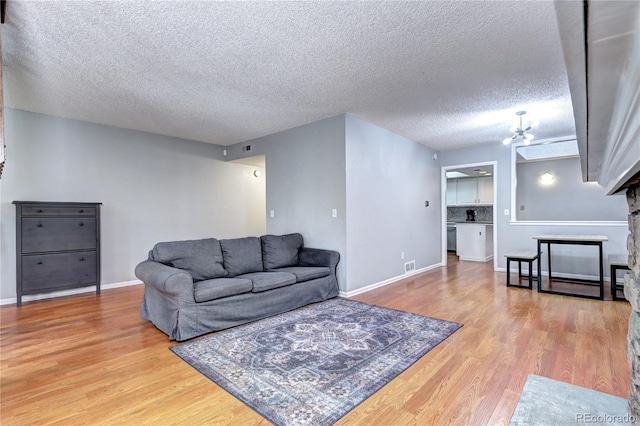 living room with a textured ceiling and hardwood / wood-style floors