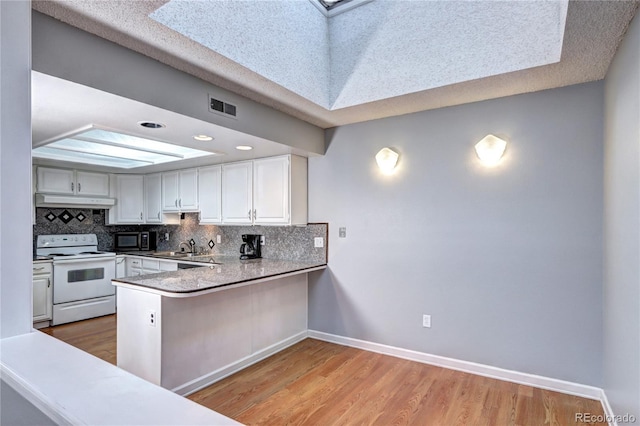 kitchen featuring white cabinetry, white range with electric cooktop, backsplash, and kitchen peninsula