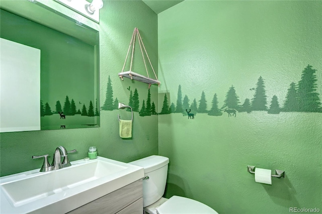 bathroom featuring toilet and vanity