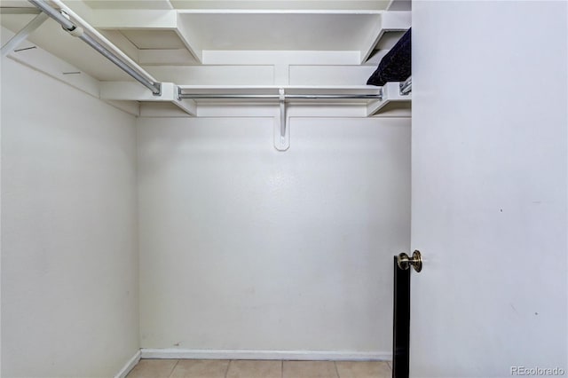 spacious closet featuring light tile patterned floors