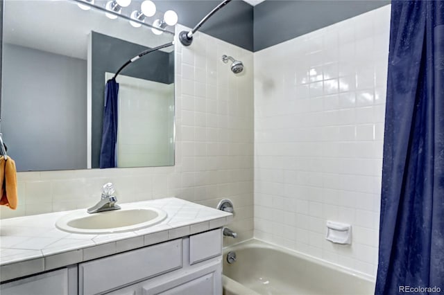 bathroom with shower / bath combination with curtain and vanity